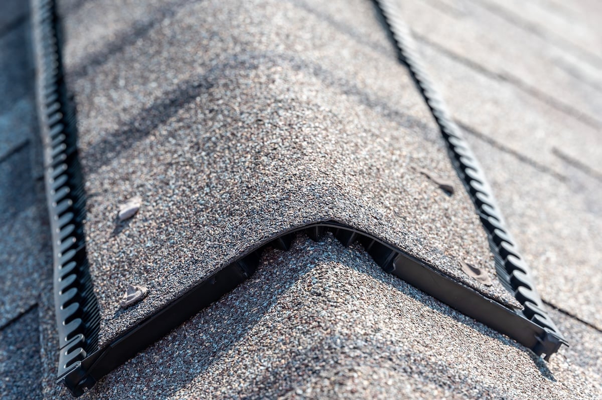 Close-up of a rooftop ridge vent installed over asphalt shingles