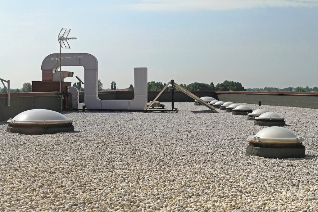 A Commercial Flat Roof With Gravel and Skylight Windows, which appears to be up to date on commercial roof maintenance.