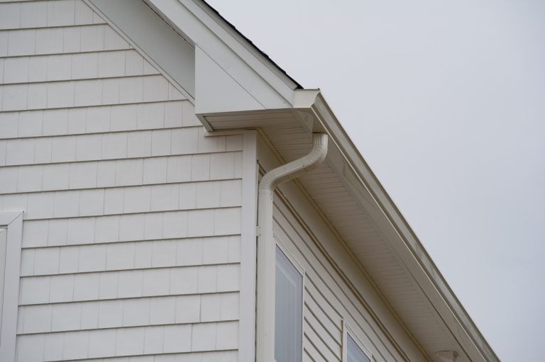 house with new seamless aluminum rain gutters pipe metal