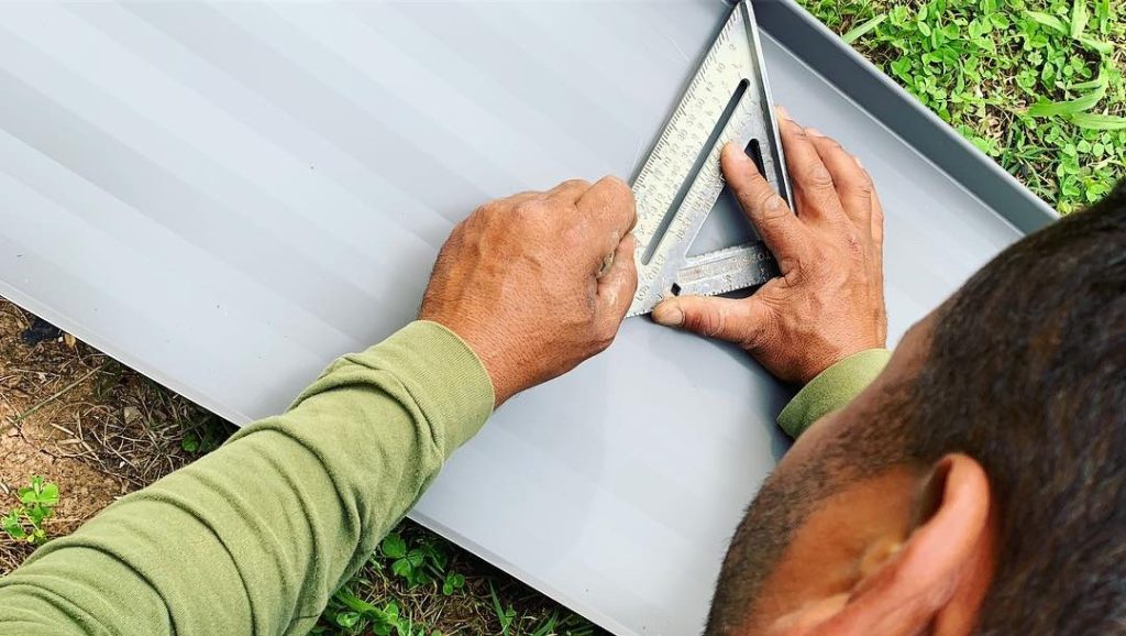 Roof medic worker doing measures for a roof replacement