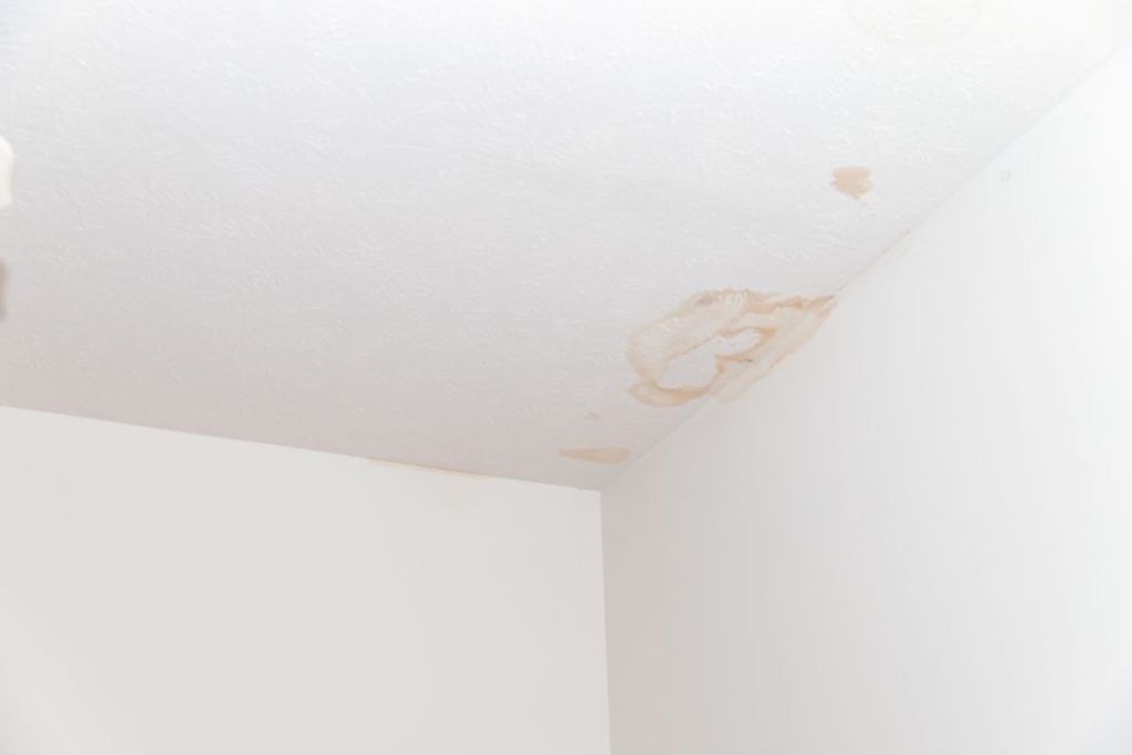Water stains on ceiling white wall inside room