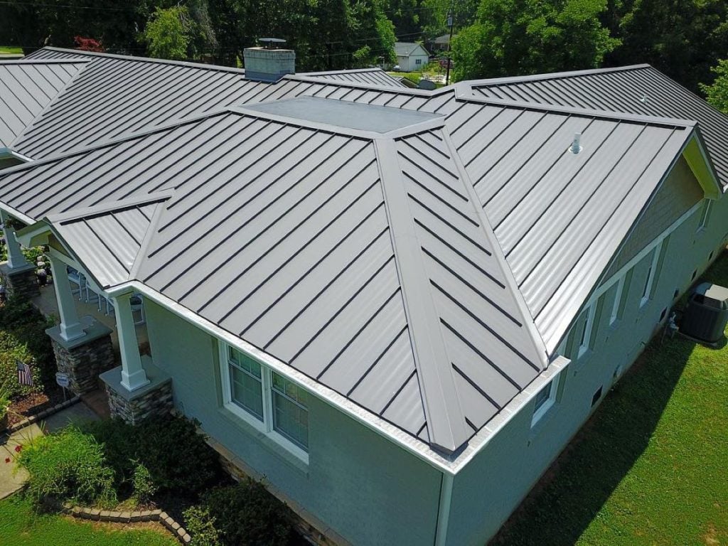 Aerial view of a house with a modern light grey metal roof flashing Roof Medic project