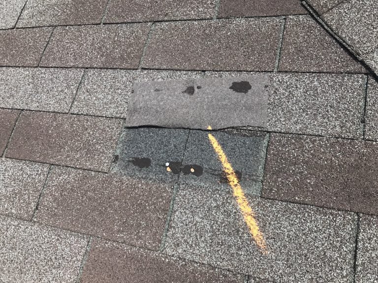 Shingle roof showing wind damage