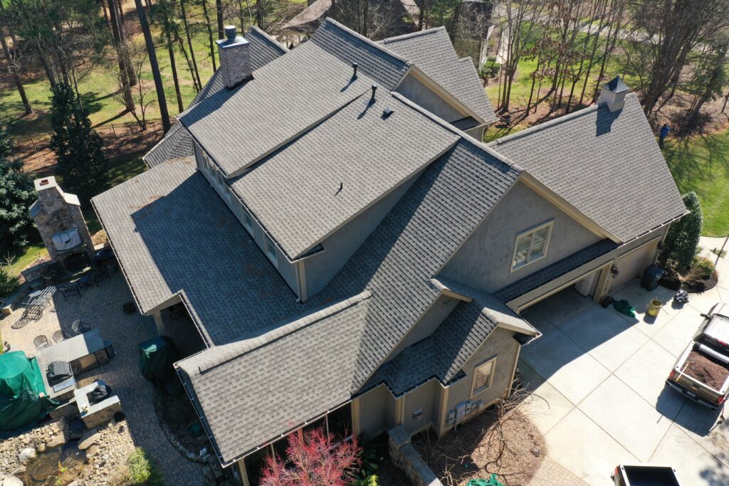 what is a gaf master elite contractor what is a gaf master elite contractor Aerial view of a modern house with a gray shingle roof, several vent pipes, and a chimney surrounded by green trees. Aerial view of a large house with gray roofs, multiple chimneys, a stone patio, and a surrounding driveway. Trees and landscaping are visible in the background.